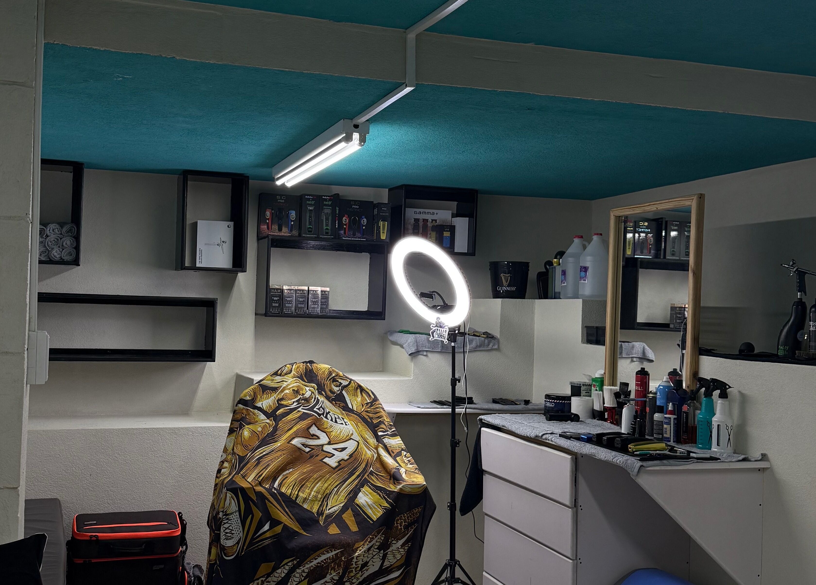 Barber station at HTB, Merricks, Saint Philip, BB featuring styling tools and ring light.
