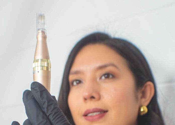 Aesthetician using a skincare tool at Velvet Skin, La Libertad, La Libertad, SV.