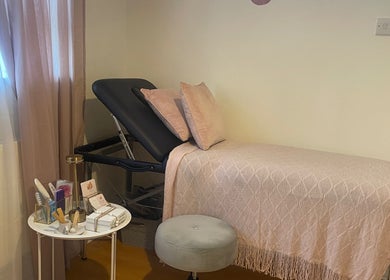 Cozy treatment room at Nails by Rachel, London, England, GB with a pink-themed decor and beauty essentials.