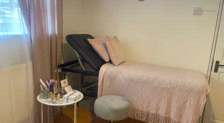 Cozy treatment room at Nails by Rachel, London, England, GB with a pink-themed decor and beauty essentials.