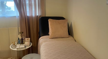 Relaxing treatment bed at Nails by Rachel, London, England, GB, with soft decor for a calming experience.