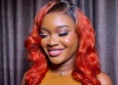 Client with radiant red curls at Elsie Beautié, Birmingham, England, GB, showcasing expert hairstyling.