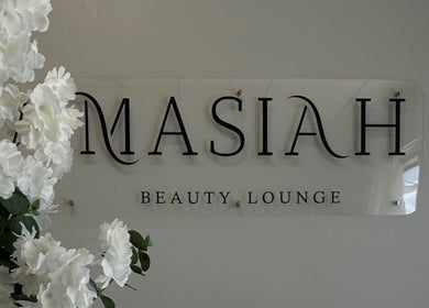Masiah Beauty Lounge elegant signage in Paramaribo, Paramaribo, SR with white floral decor.