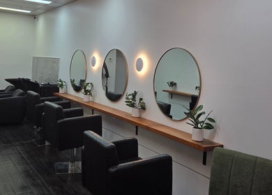 Modern salon interior of Papillon salon in Hendra, Queensland, AU with stylish mirrors and seating.