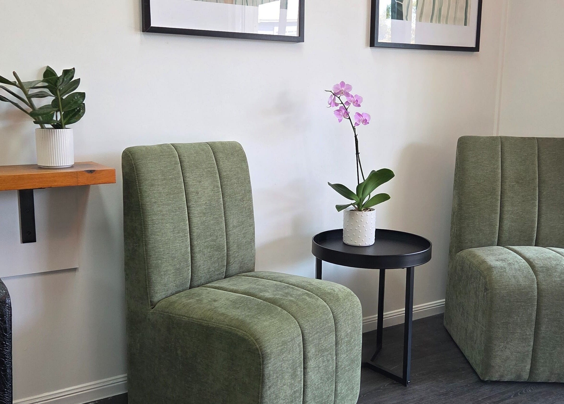 Elegant seating area at Papillon salon, Hendra, Queensland, AU with plush chairs and a potted orchid.