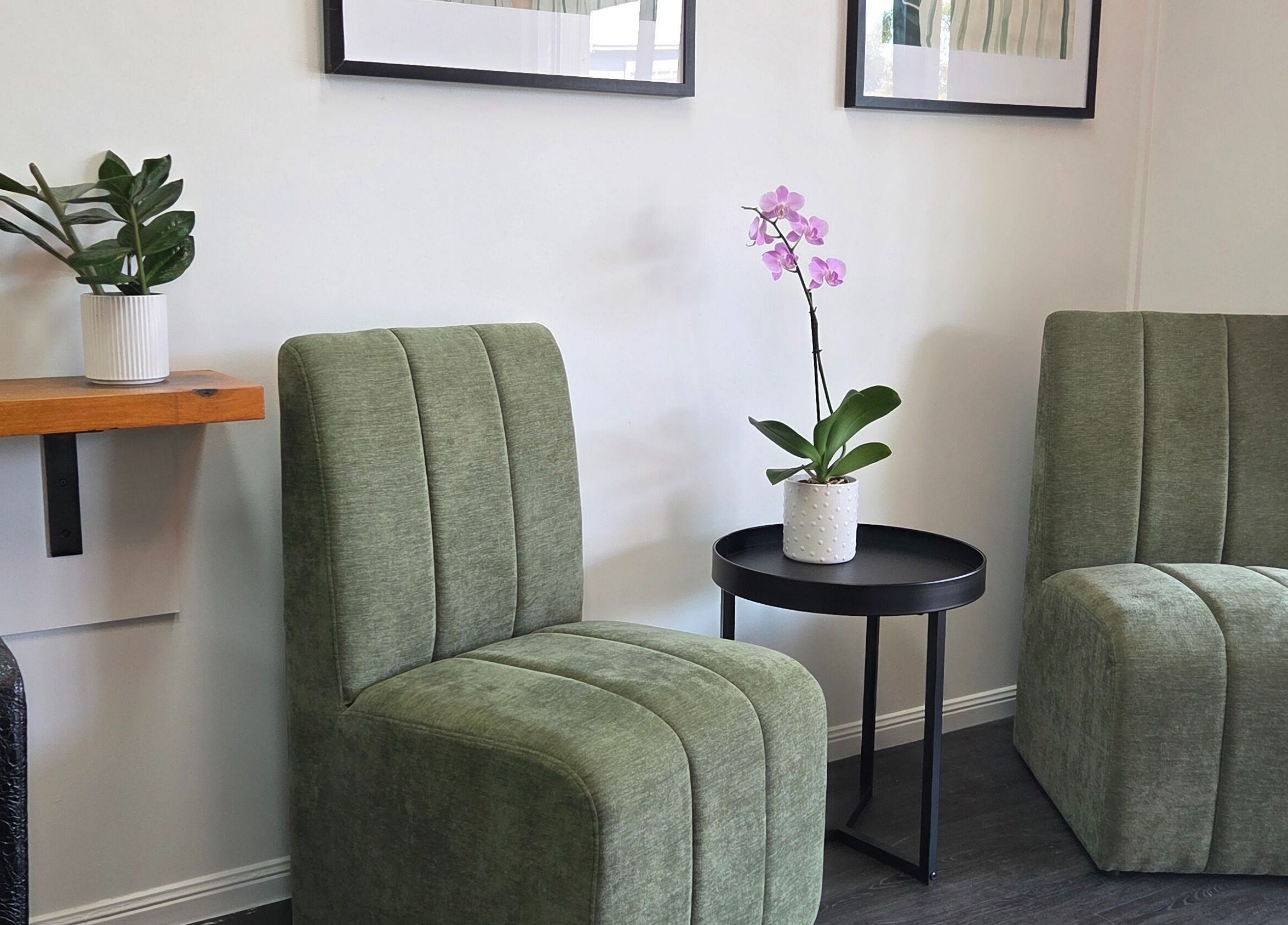 Elegant seating area at Papillon salon, Hendra, Queensland, AU with plush chairs and a potted orchid.