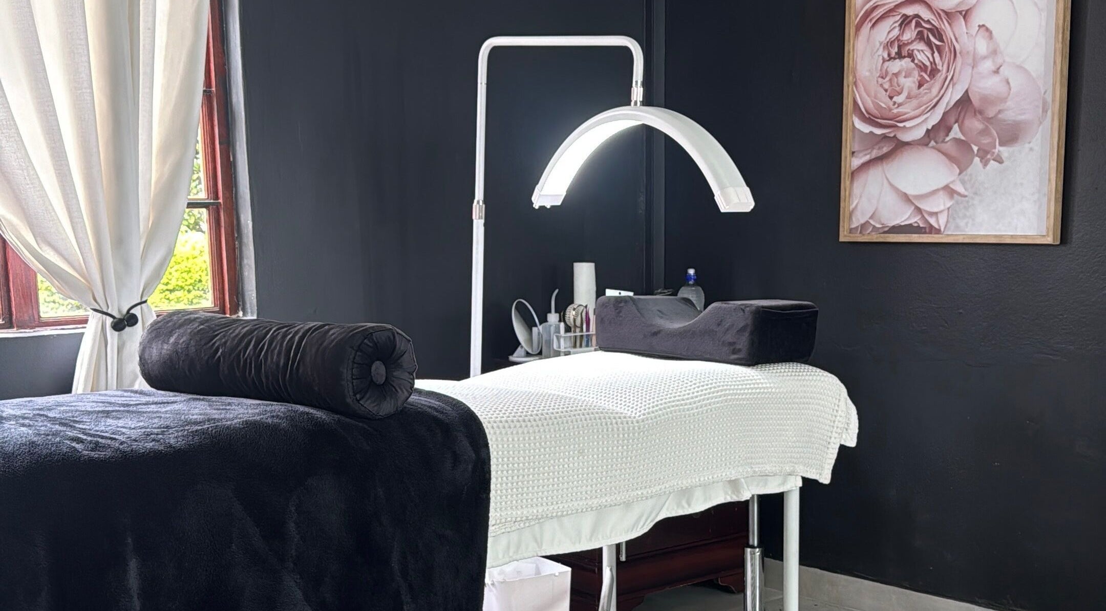 Serene treatment room at Bella Tu Beauty Styling, Pretoria, Gauteng, ZA with a massage table and floral decor.
