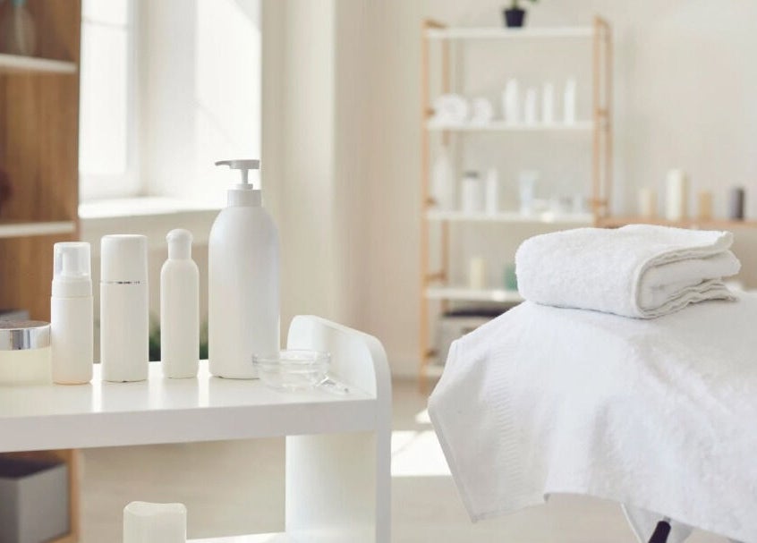 Spa treatment room at New Era Brows & Beauty, Chiswick, New South Wales, AU. White towels and skincare products.