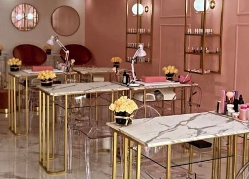 Elegant nail salon interior at XO' Beauty by Micaela, Johannesburg, Gauteng, ZA with marble tables and modern decor.