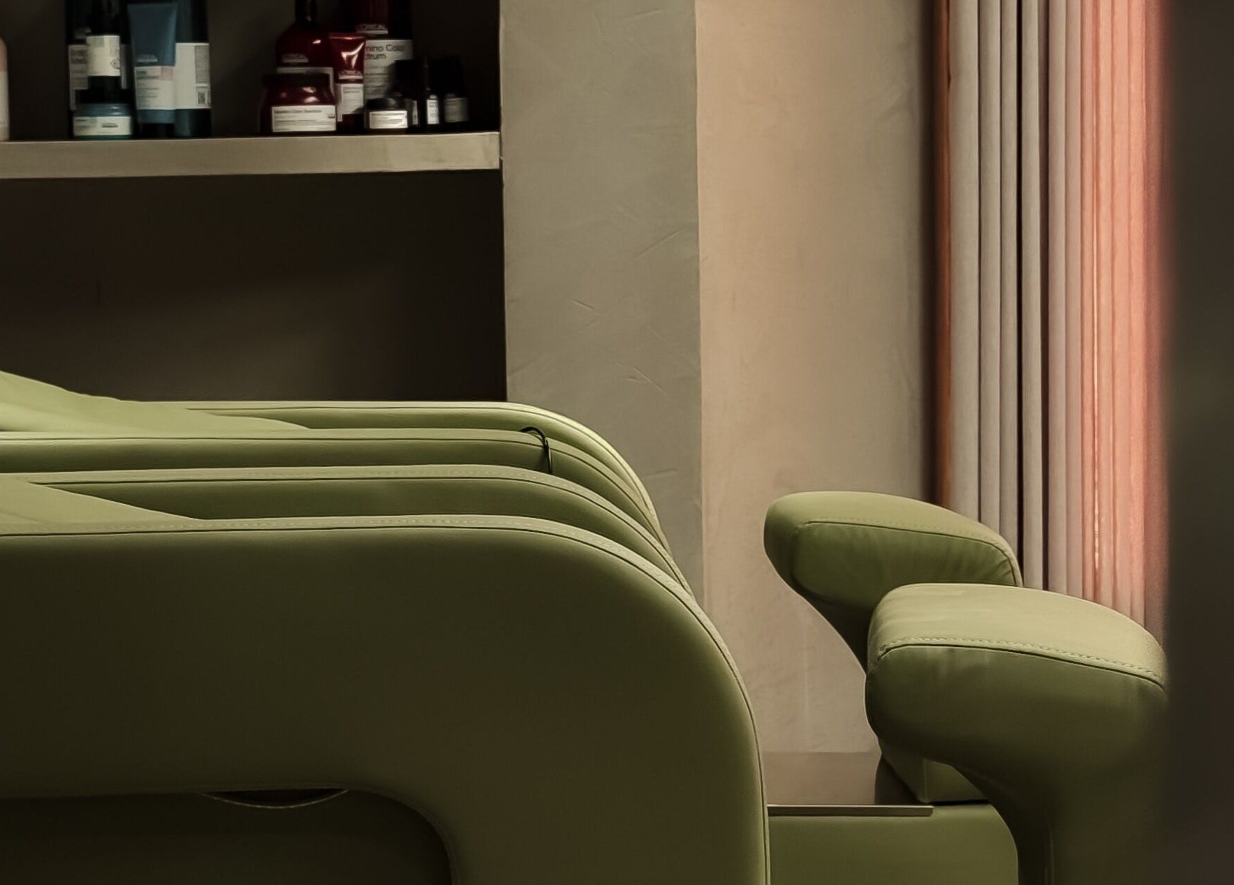Green spa chairs at Double H Salon & Spa, Hail, Hail Province, SA offer relaxation and comfort.