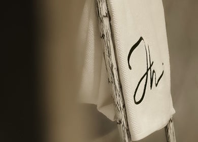 Elegant embroidered towel on rustic ladder at Double H Salon & Spa, Hail, Hail Province, SA.