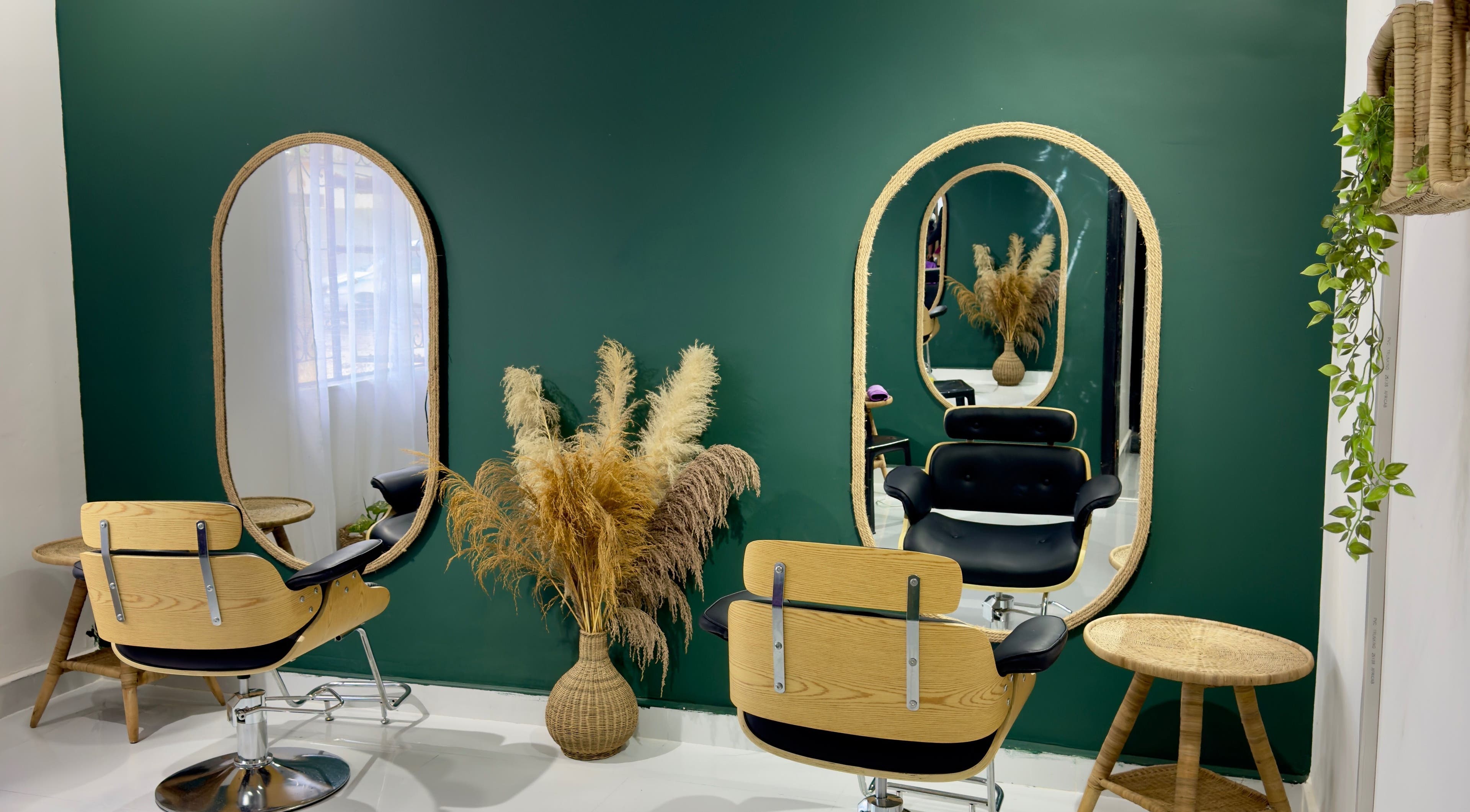 Stylish salon setup at Bloom by Her Rootz - Woodlands in Lusaka, Lusaka Province, ZM with mirrors and green walls.