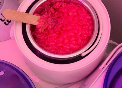 Pink wax granules melting at Bloom_hays_beauty, Nottingham, England, GB, enhancing your beauty experience.