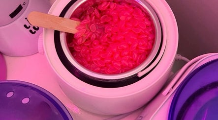 Pink wax granules melting at Bloom_hays_beauty, Nottingham, England, GB, enhancing your beauty experience.