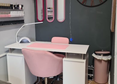 Nail treatment station at Nikki Nailed It @ Tease 2, Hazel Grove, England, GB, featuring pink décor and organized polishes.