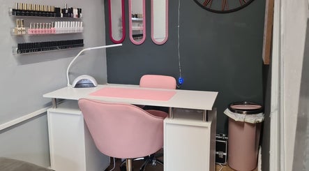 Nail treatment station at Nikki Nailed It @ Tease 2, Hazel Grove, England, GB, featuring pink décor and organized polishes.