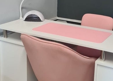 Elegant nail station at Nikki Nailed it @ Tease 2, Hazel Grove, England, GB with pink chair and mat.