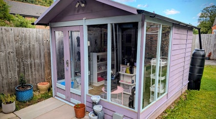 Charming garden studio at Nikki Nailed It in Hazel Grove, England, GB, surrounded by colorful pots.