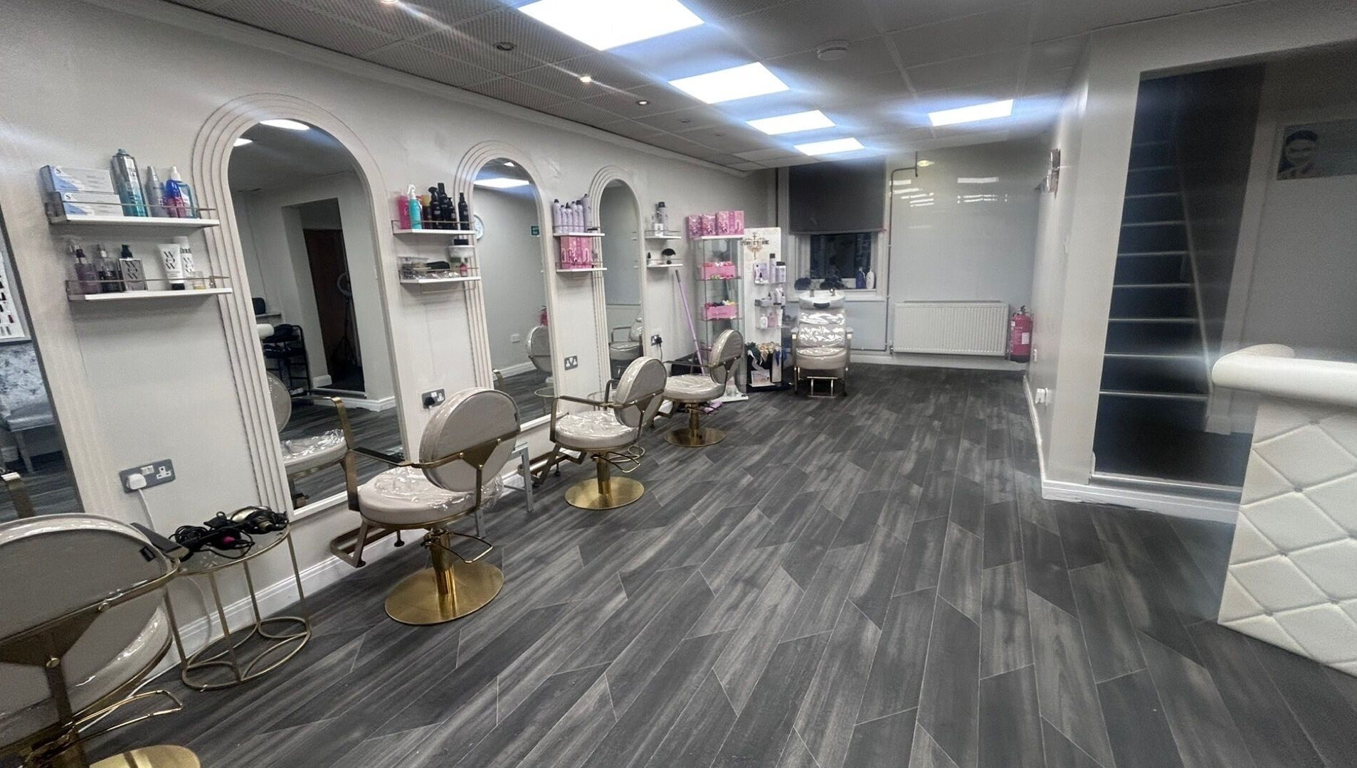 Modern salon interior at B’Glammed By Us, Leyland, England, GB with elegant styling stations and decor.