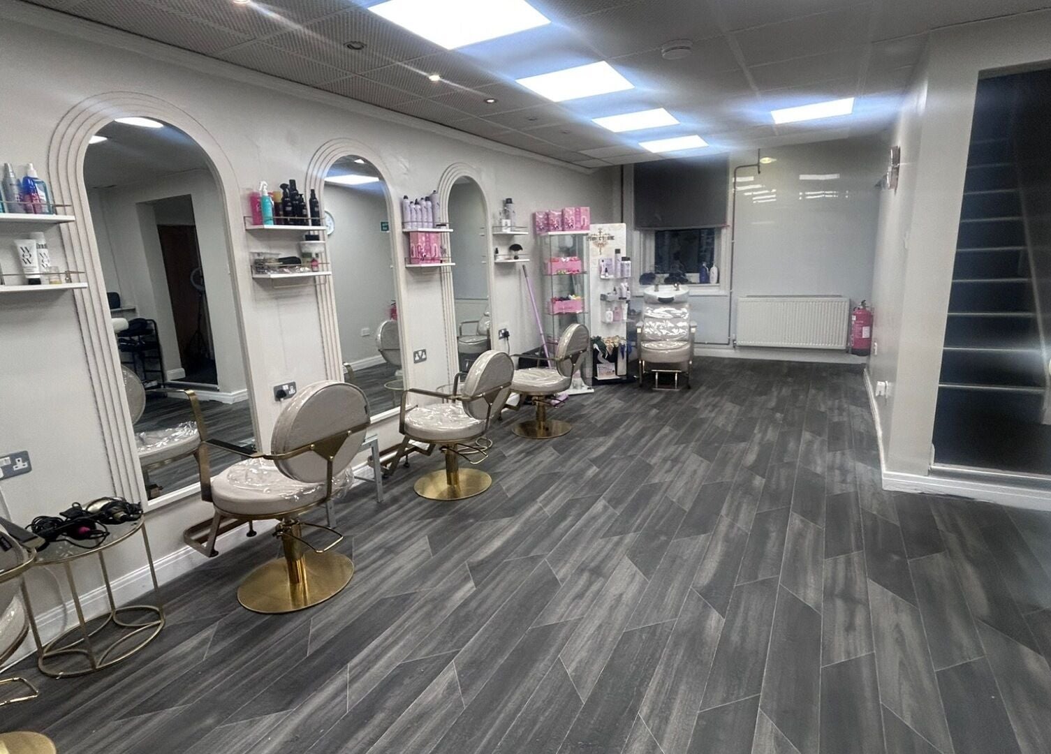 Modern salon interior at B’Glammed By Us, Leyland, England, GB with elegant styling stations and decor.