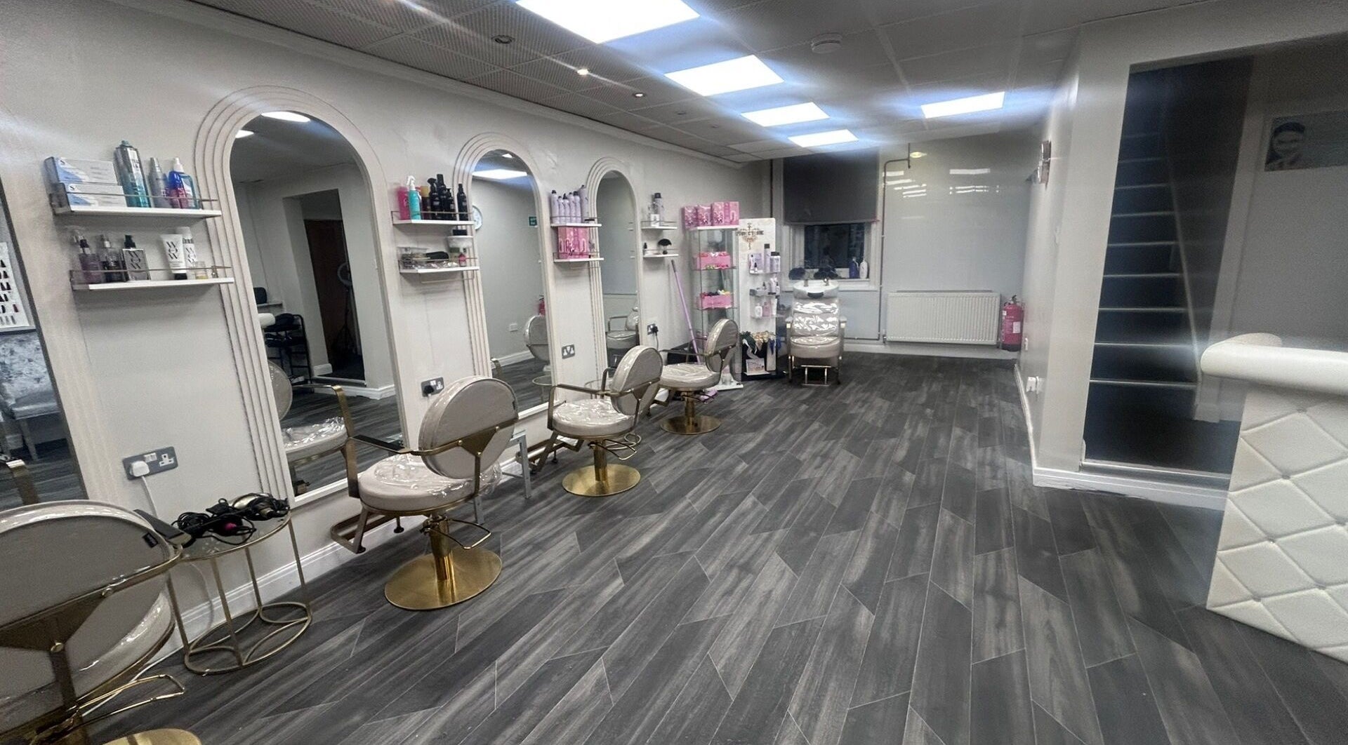 Modern salon interior at B’Glammed By Us, Leyland, England, GB with elegant styling stations and decor.