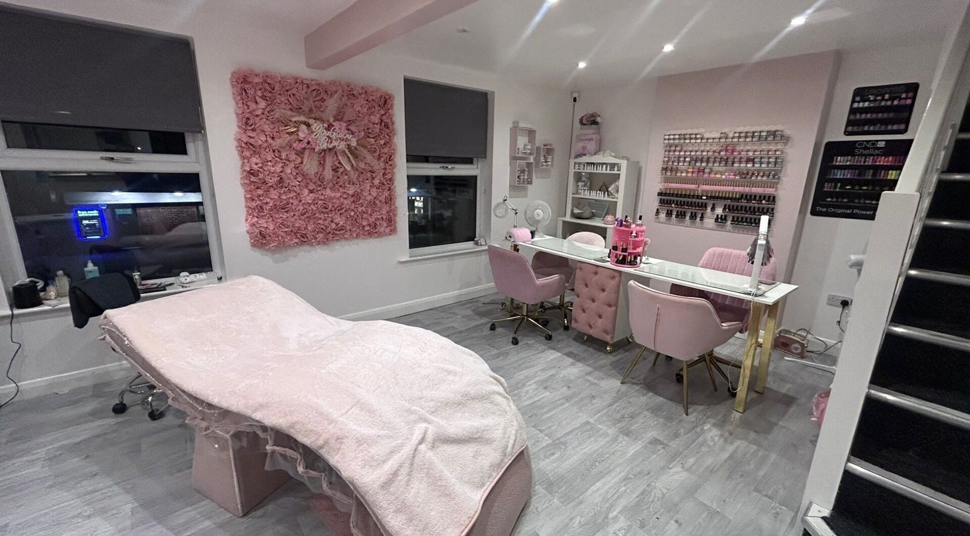 Chic interior of B’Glammed By Us in Leyland, England, featuring blush decor and styling stations.