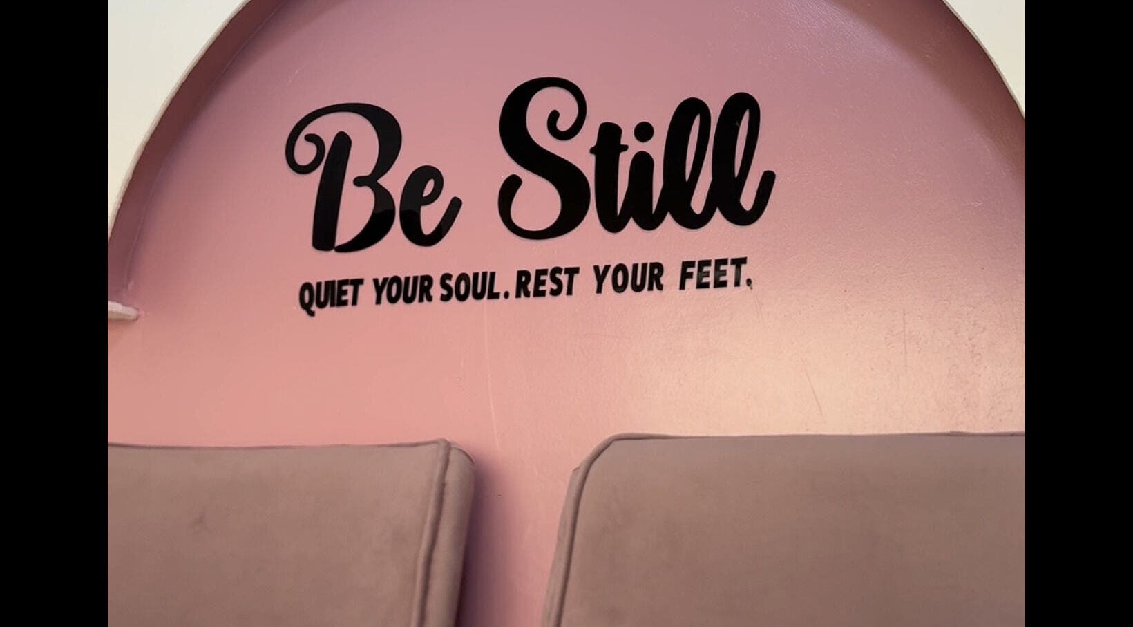 Femme Spa And Body Works Maryland in Lagos, NG features a calming pink wall with 'Be Still' quote for relaxation.