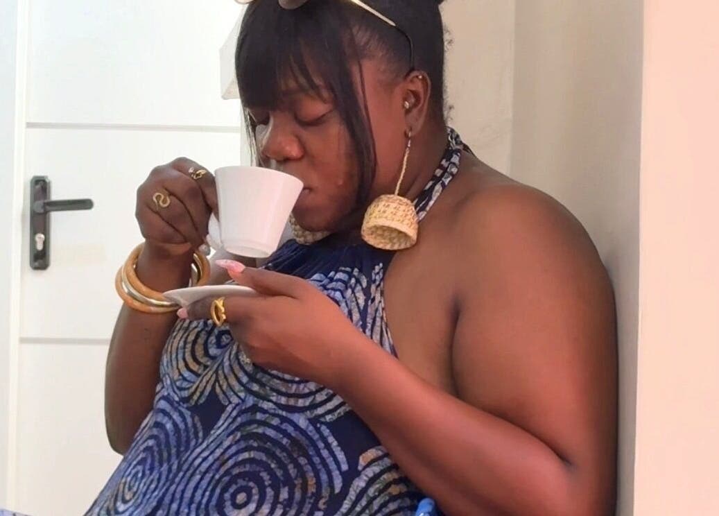 Guest enjoys tea at Femme Spa And Body Works Maryland in Lagos, Lagos, NG, embodying relaxation and wellness.