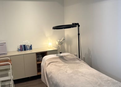 SkinByBrooke treatment room in Toronto, Ontario, CA with cozy massage bed and well-organized skincare products.