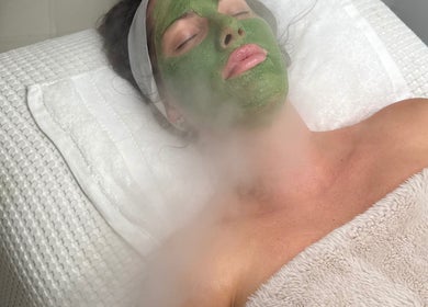 Relaxing facial treatment at SkinByBrooke in Toronto, Ontario, CA with soothing green mask and steam therapy.