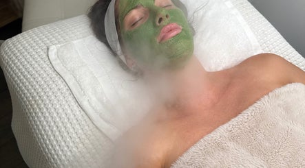 Relaxing facial treatment at SkinByBrooke in Toronto, Ontario, CA with soothing green mask and steam therapy.