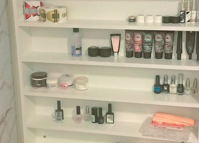 Nail products neatly arranged in shelves at The Nail Statement & Beauty Spa, Gqeberha, Eastern Cape, ZA.
