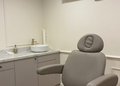 Spacious treatment room at Brow Studio London, featuring a stylish chair and sink in London, England, GB.