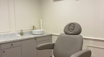 Spacious treatment room at Brow Studio London, featuring a stylish chair and sink in London, England, GB.