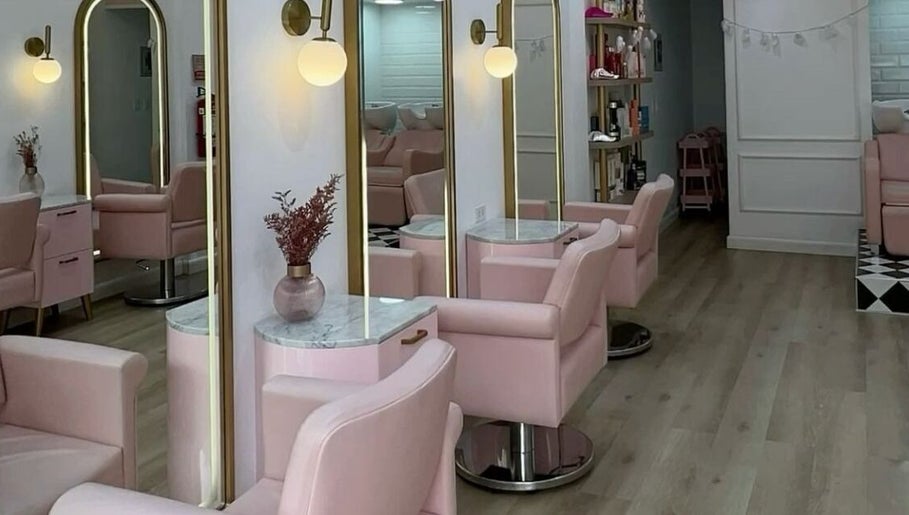 Chic interior of Qasar Al Yasmeen Ladies Saloon in Sharjah, Sharjah, AE with pink chairs and stylish mirrors.