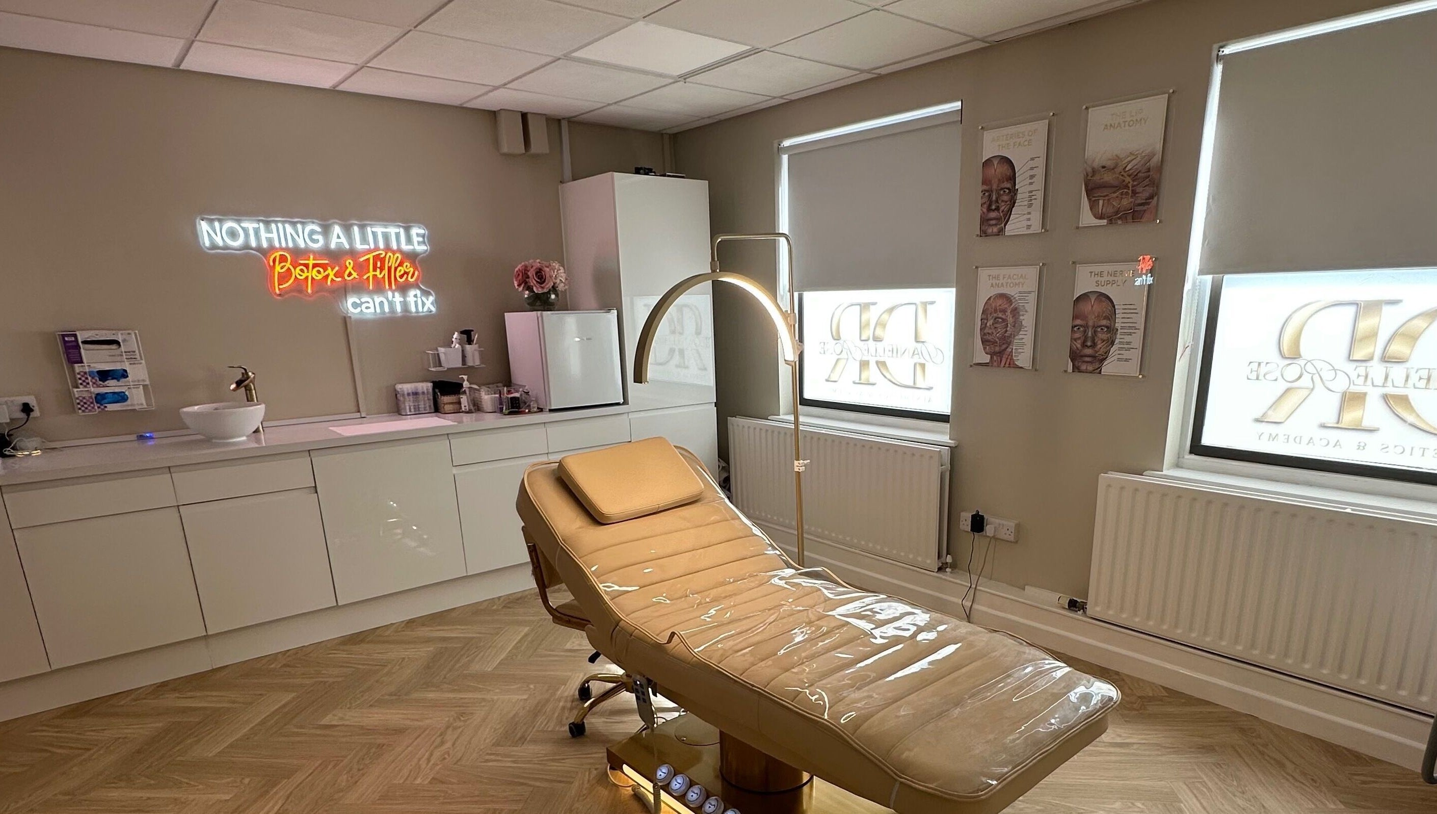 Modern treatment room at Danielle Rose Aesthetics, Southampton, England, GB with a sleek chair and neon sign.