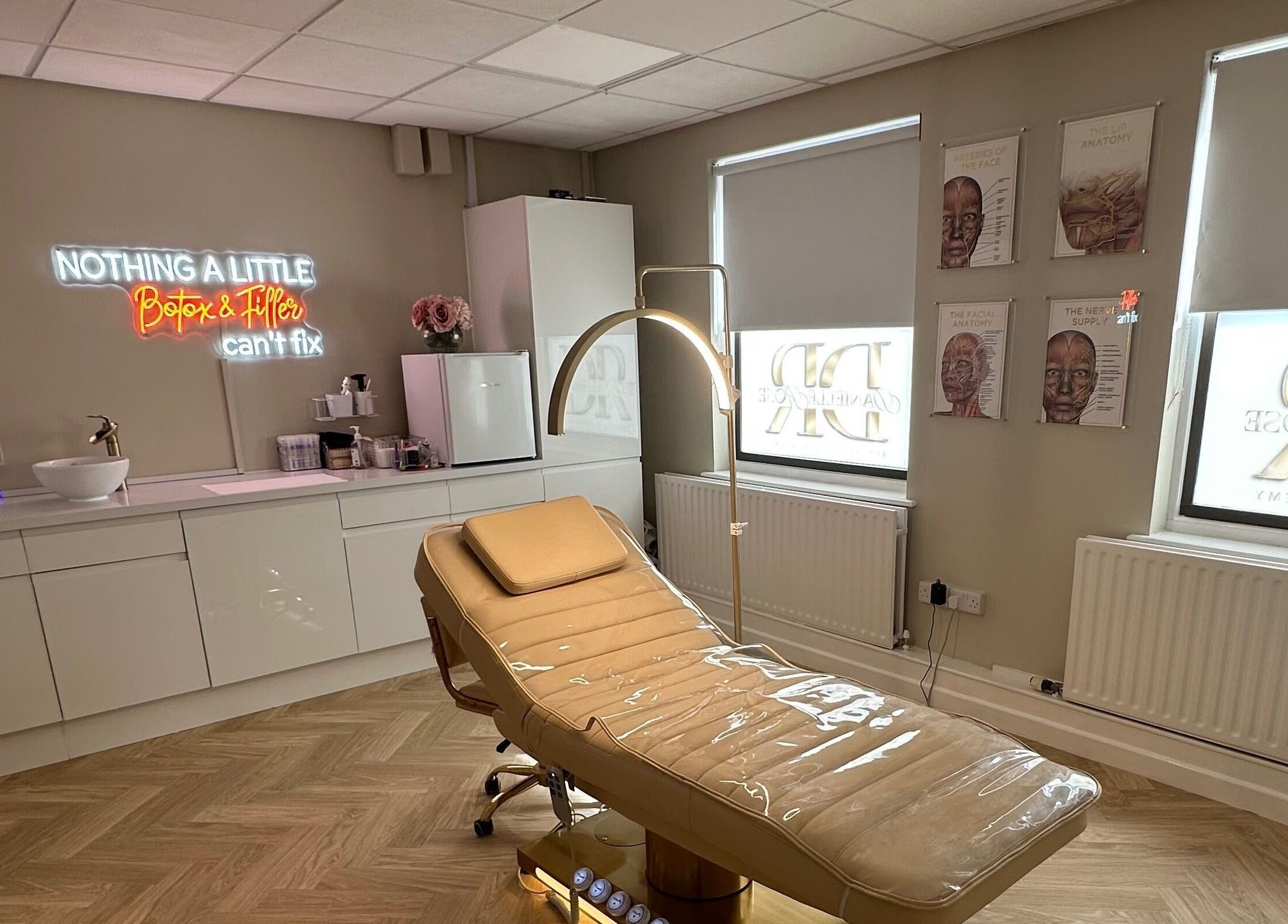 Modern treatment room at Danielle Rose Aesthetics, Southampton, England, GB with a sleek chair and neon sign.