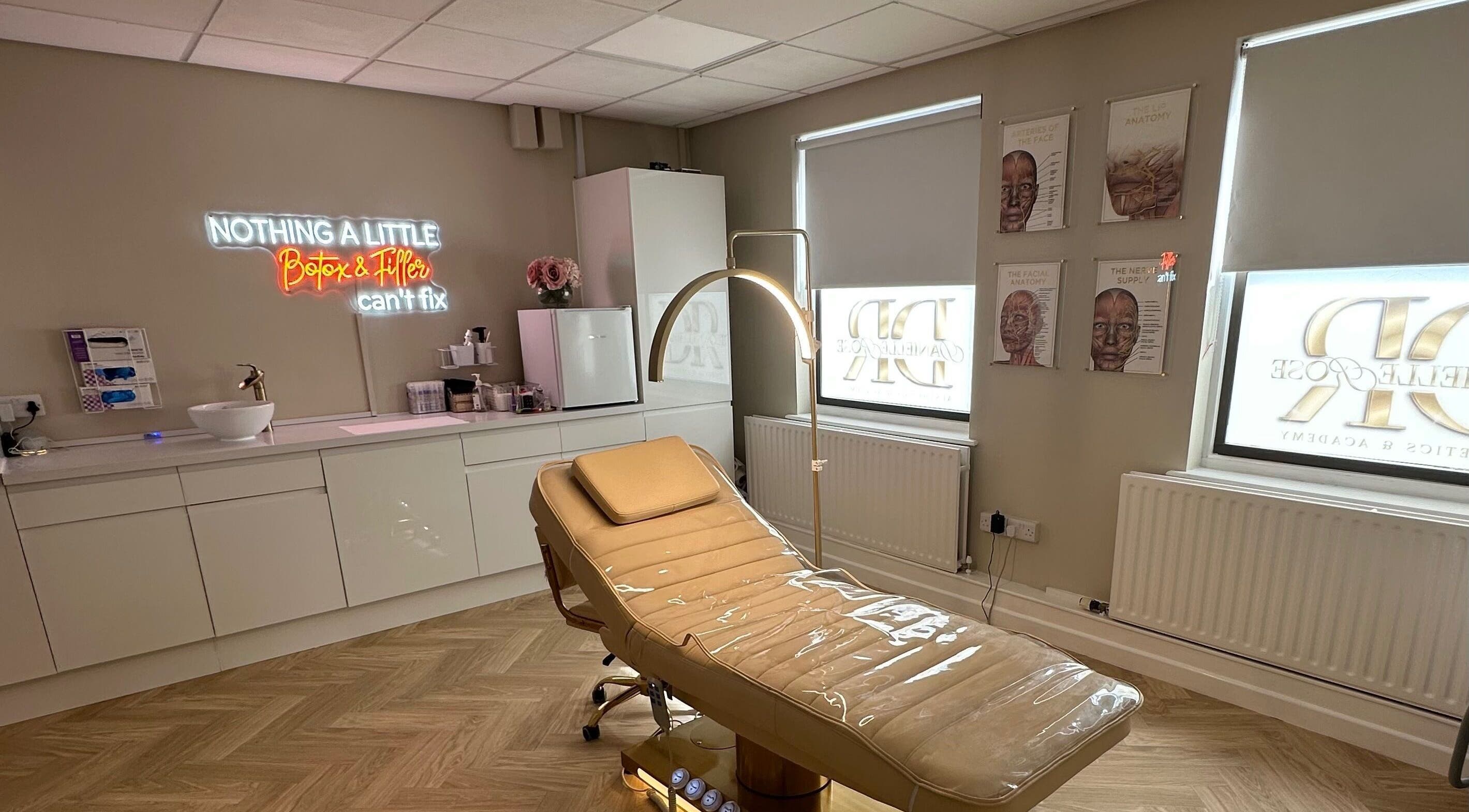 Modern treatment room at Danielle Rose Aesthetics, Southampton, England, GB with a sleek chair and neon sign.