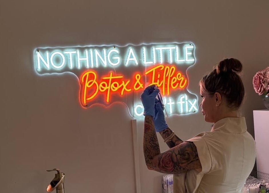 Professional at Danielle Rose Aesthetics in Southampton, England, under neon 'Botox & Filler' sign.