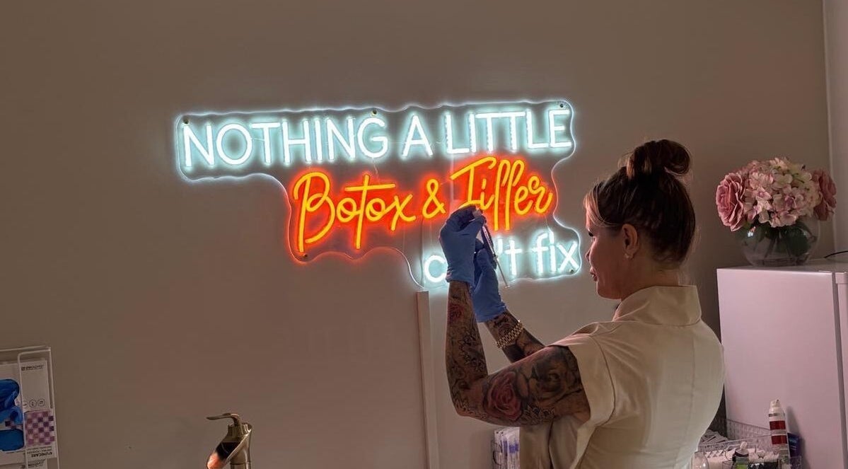 Professional at Danielle Rose Aesthetics in Southampton, England, under neon 'Botox & Filler' sign.