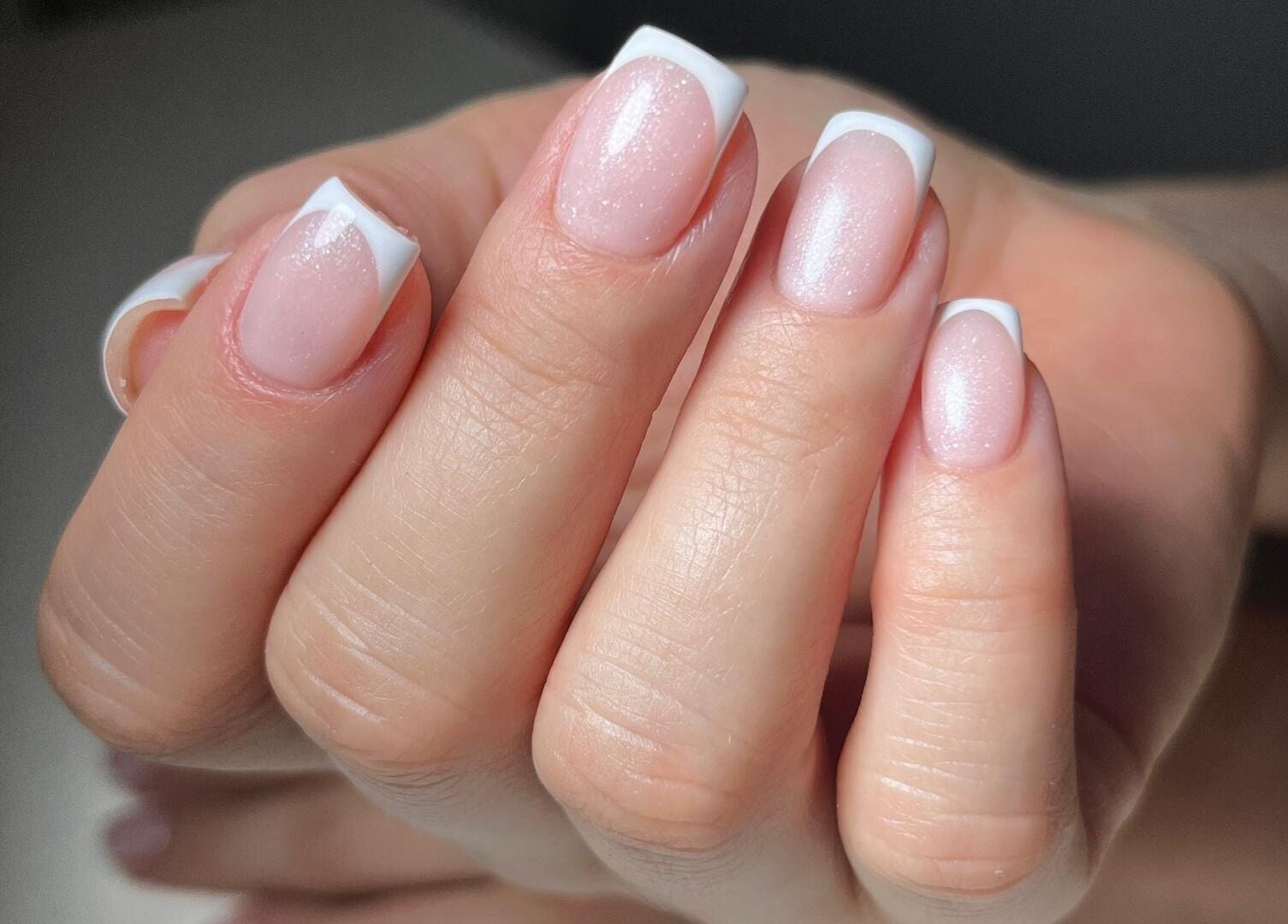 Elegant French manicure at Mariana Nails, Caracas, Distrito Capital, VE with glossy white tips.