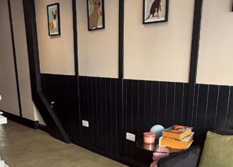 Stylish waiting area at Teddy’s Tailored Trims in Penrith, England, GB, with framed artworks and cushions.