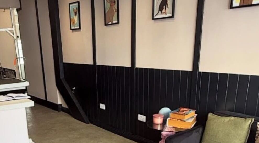 Stylish waiting area at Teddy’s Tailored Trims in Penrith, England, GB, with framed artworks and cushions.