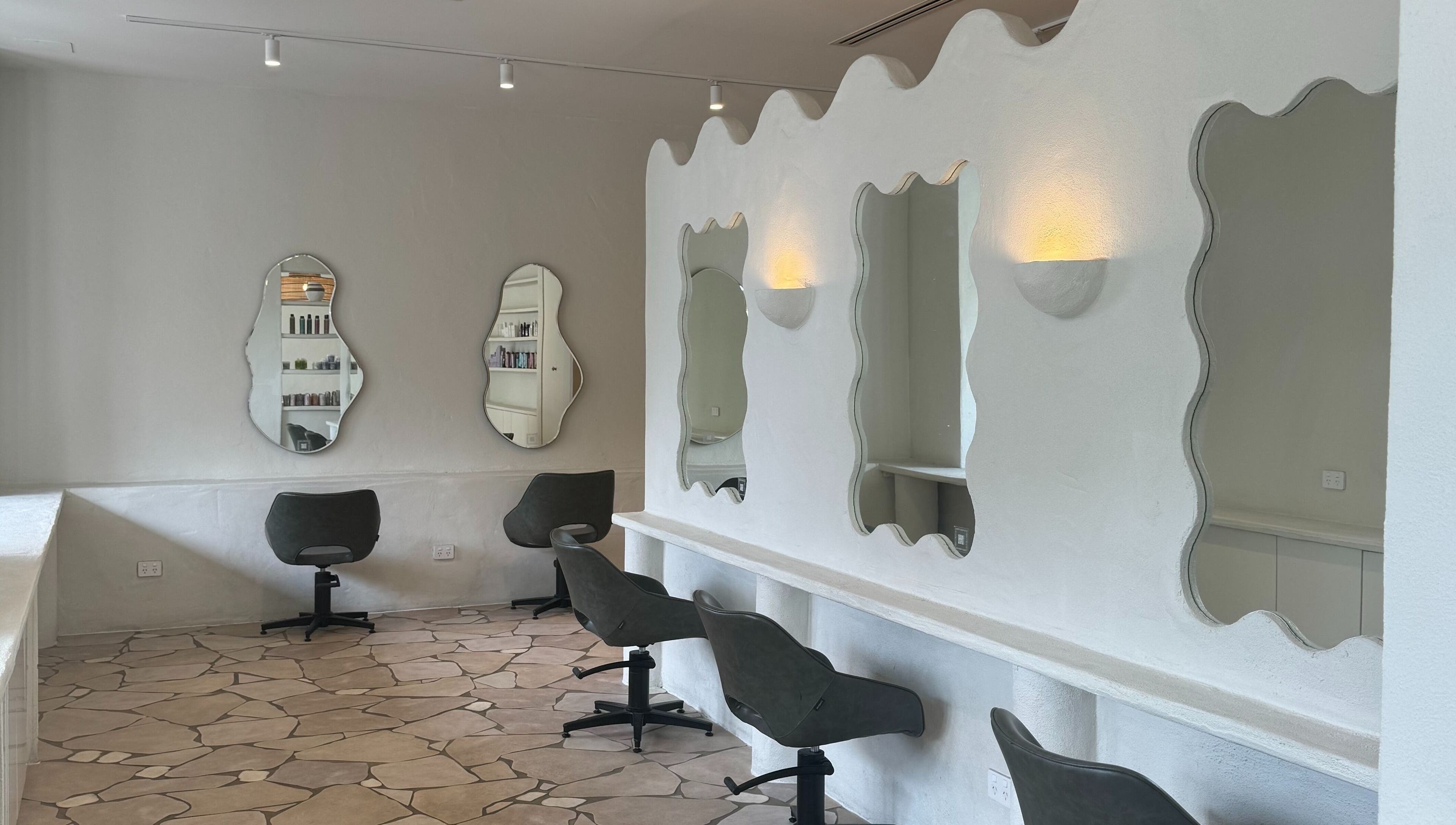 Modern salon interior at Farrah Studio in New Farm, Queensland, AU with stylish mirrors and chairs.