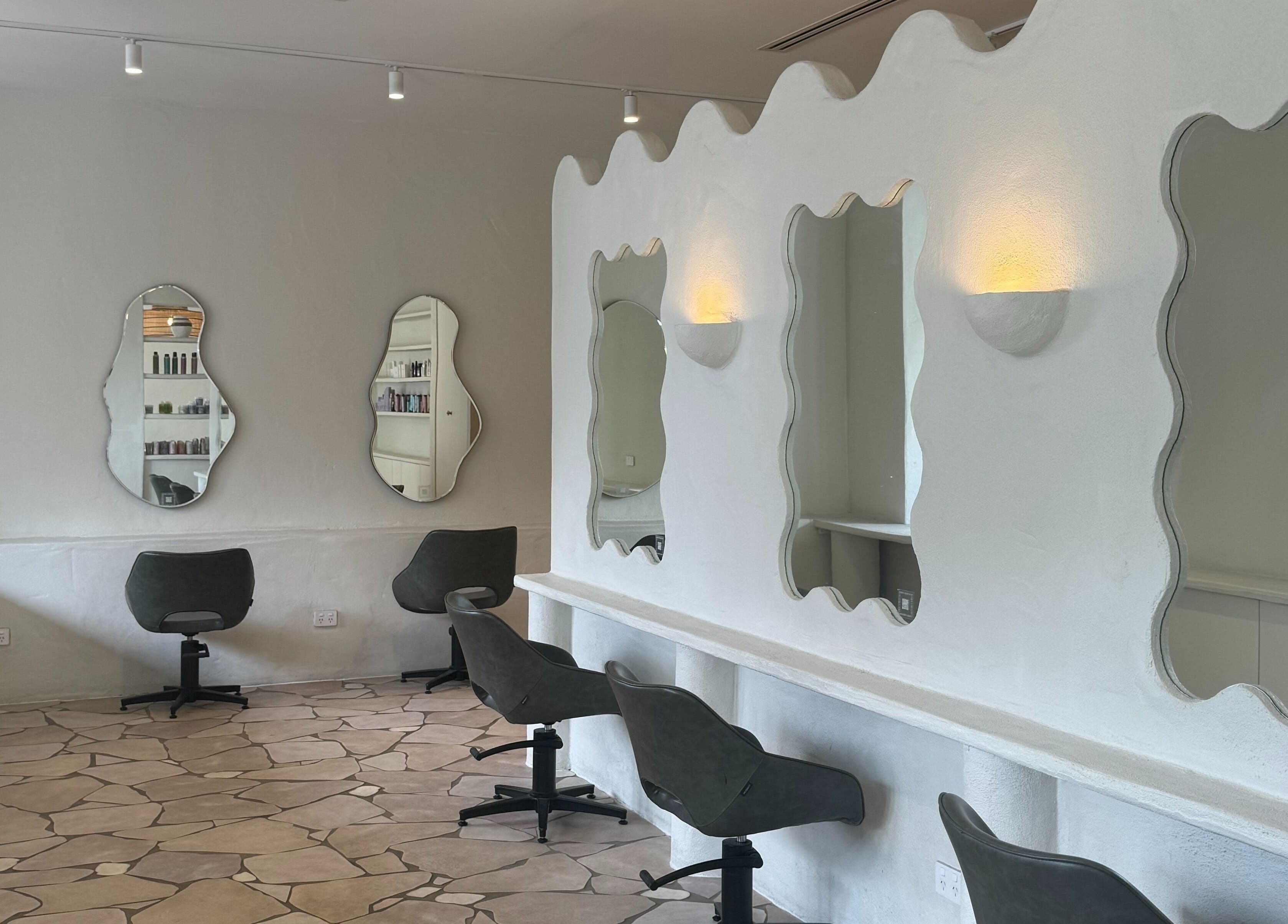Modern salon interior at Farrah Studio in New Farm, Queensland, AU with stylish mirrors and chairs.