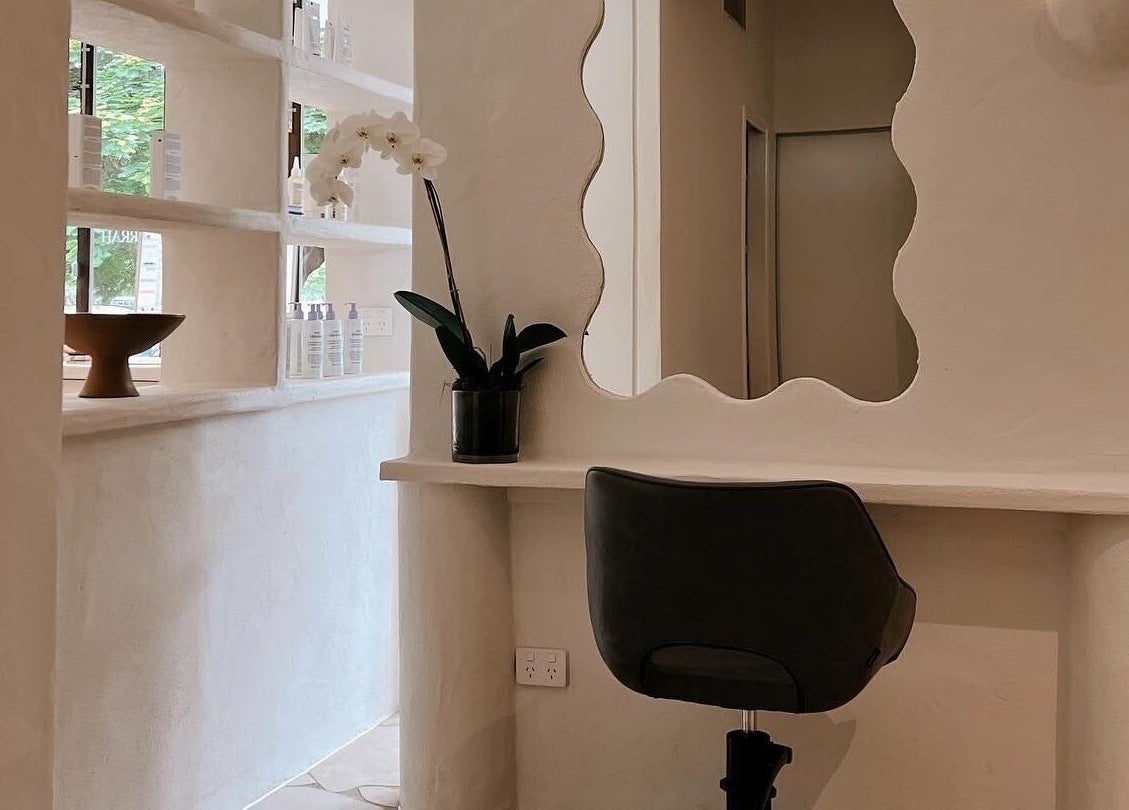Elegant styling area at Farrah Studio with a wavy mirror in New Farm, Queensland, AU.
