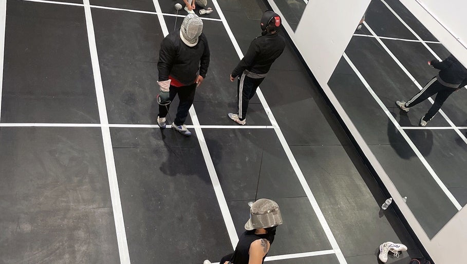 Fencing practice at Fence MI Fencing Academy in Las Vegas, Nevada, US, featuring athletes in action on the piste.