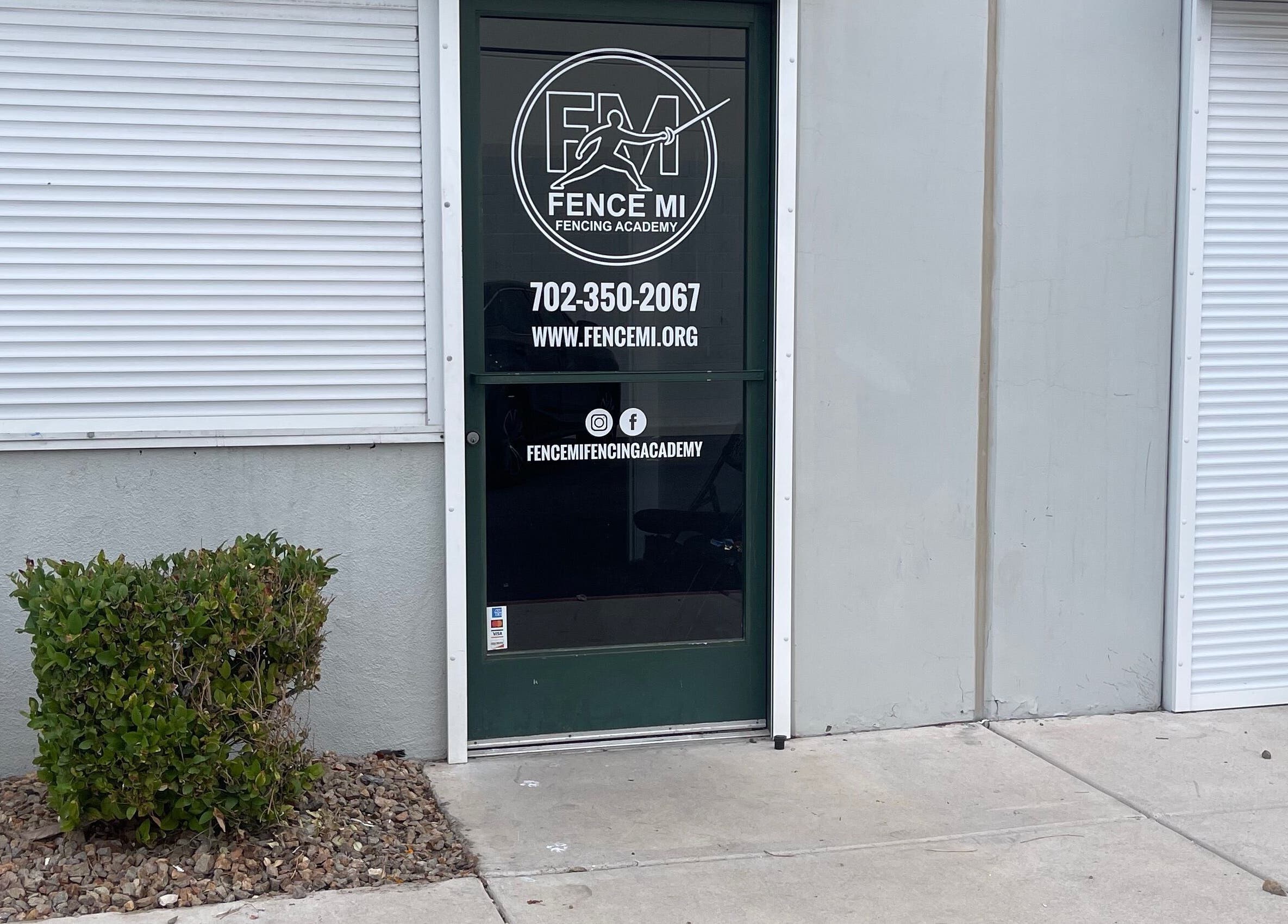 Entrance of Fence MI Fencing Academy in Las Vegas, Nevada, US, featuring contact details on a glass door.