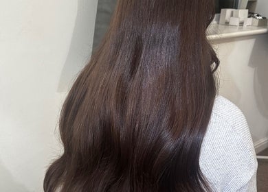 Luxelocksbyizz in Brentwood, England, GB showcases glossy brown hair cascading smoothly down.
