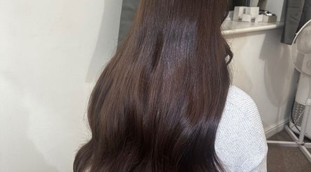 Luxelocksbyizz in Brentwood, England, GB showcases glossy brown hair cascading smoothly down.